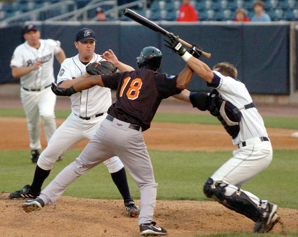 Bridgeport Bluefish catcher John Nathans tries to prevent Long Island Duck's (18) Jose Offerman from hitting Bluefish pitcher Matt Beech with a bat during an Atlantic League baseball game in Bridgeport, Conn. on Tuesday, Aug. 14, 2007. Beech struck Offerman with a pitch, causing Offerman to rush the mound. Offerman was later arrested on charges of second-degree assault.