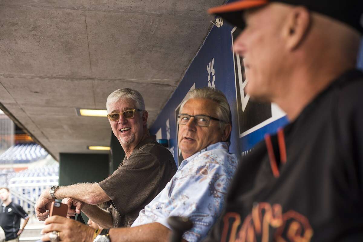 Mike Krukow, long-time television color commentator for the San Francisco Giants, and co-commentator Duane Kuiper, speak with third base coach Tim Flannery before the game at Citizen's Bank Park in Philadelphia, PA, on July 21, 2014.