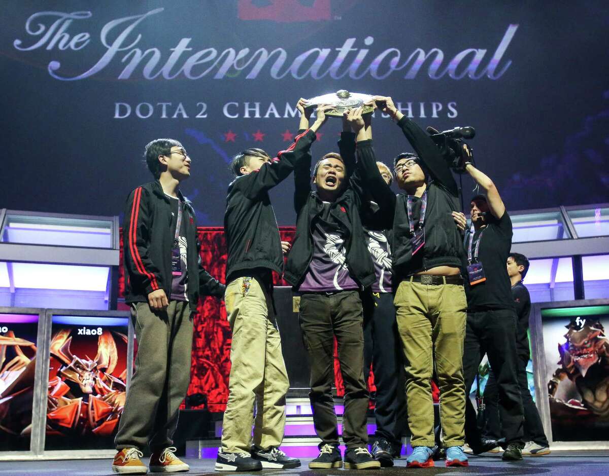 Team NewBee hoists the Aegis of Champions trophy after winning The International DOTA 2 Championships. Thousands packed KeyArena to watch The International DOTA 2 Championships on Monday, July 21, 2014. The Chinese team NewBee took home the Aegis of Champions after beating Vici Gaming in three out of four games.