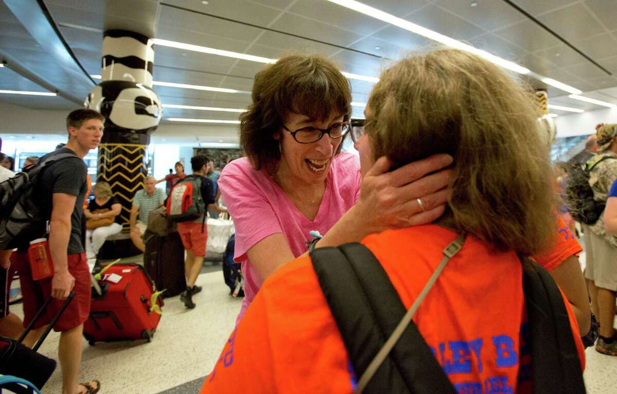 Relieved parent Wendy Suttin holds on to her daughter Beth Suttin who just arrived back from a three week trip in Israel Monday, July 21, 2014 at at Bush Intercontinental Airport. 