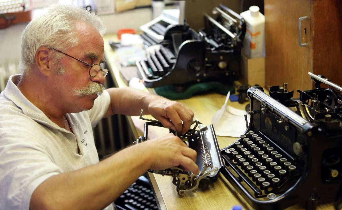 Typewriter repairman Bernd Moser fixes a Continental manual typewriter from the 1930s on July 22, 2014 at the Arndt Hans Joachim Bueromaschinen office supply store in Berlin, Germany.
