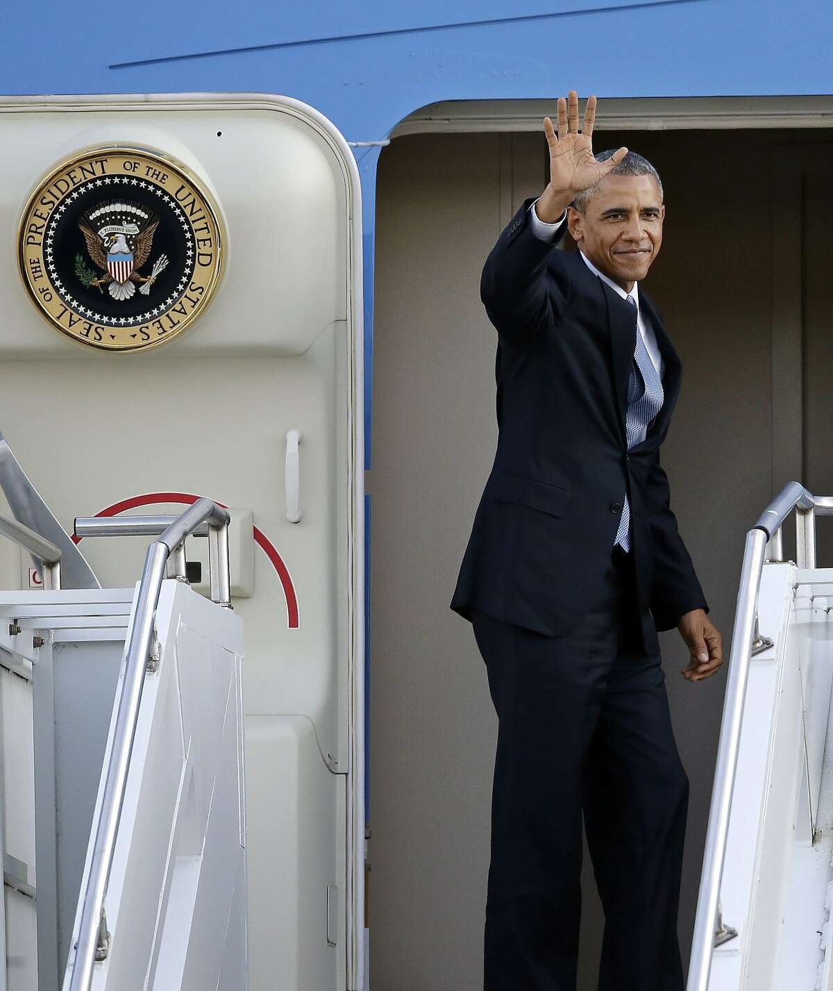President Barack Obama waves as he prepares to depart Tuesday, July 22, 2014, from King County International Airport in Seattle. Obama is on a three-day West Coast trip that included at least five fundraising events in Seattle, San Francisco and Los Angeles. (AP Photo)