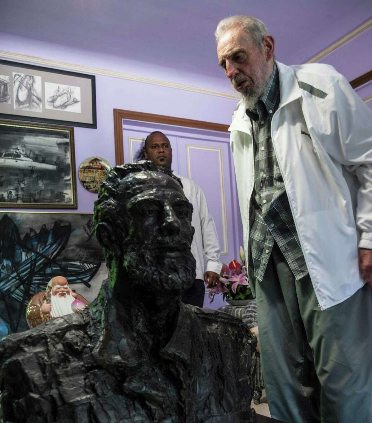 Cuba's Fidel Castro looks at a sculpture of himself, a gift from China's President Xi Jinping in Havana, Cuba, Tuesday, July 22, 2014. Xi Jinping said that his state visit to Cuba is aimed at carrying forward the traditional friendship between the two countries jointly built by Castro and the older generations of Chinese leaders. He also extended good wishes to Castro for his upcoming 88th birthday. (AP Photo/Alex Castro)
