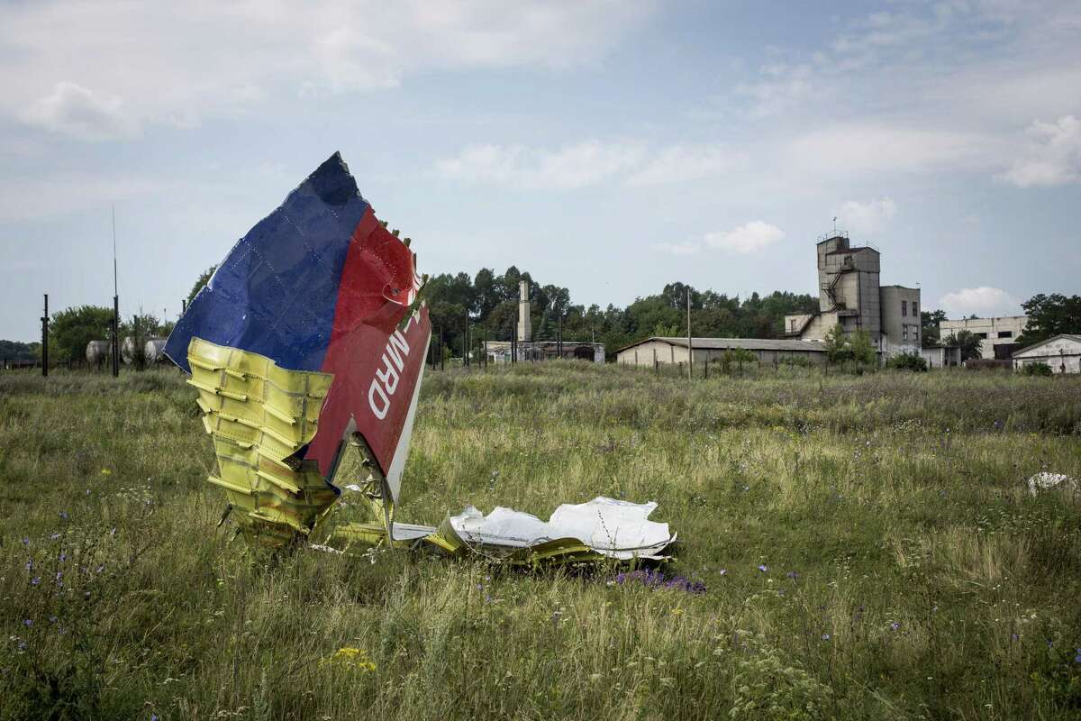 Wreckage from Malaysia Airlines flight MH17 lies in a field in Ukraine. Regardless of who pulled the trigger, Russia bears the blame for providing weapons to non-state groups.