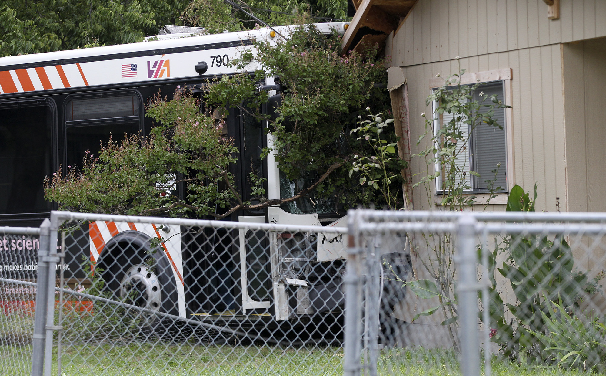 Three-vehicle Crash Sends VIA Bus Into House