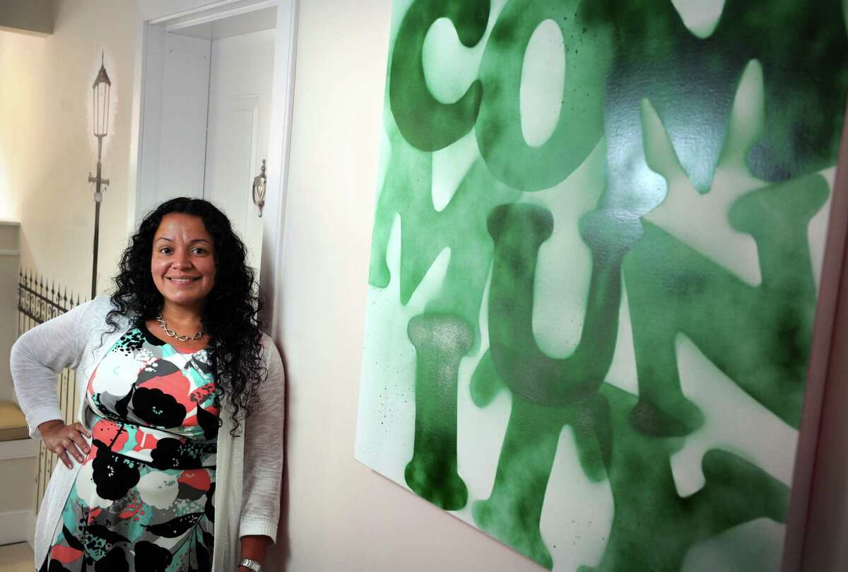 Liz Torres, executive director of Bridgeport Neighborhood Trust, a nonprofit that develops properties and offers homeownership counseling, stands in the group's new office on State Street in Bridgeport, Conn.