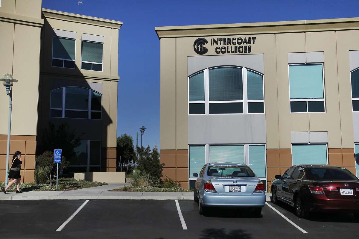 A woman walks near the building in which Intercoast College is located June 17, 2014 in Fairfield, Calif.