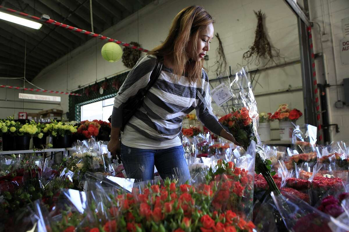 Designer Kimberly Lau of Bings Design shops for flowers at Neve Roses in the Flower Mart in San Francisco, CA, Thursday, July 24, 2014.