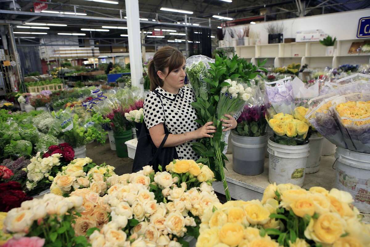 Erin Newman of Grant K. Gibson Interior Design shops for flowers at Torchio Nursery at the Flower Mart in San Francisco, CA, Thursday, July 24, 2014.