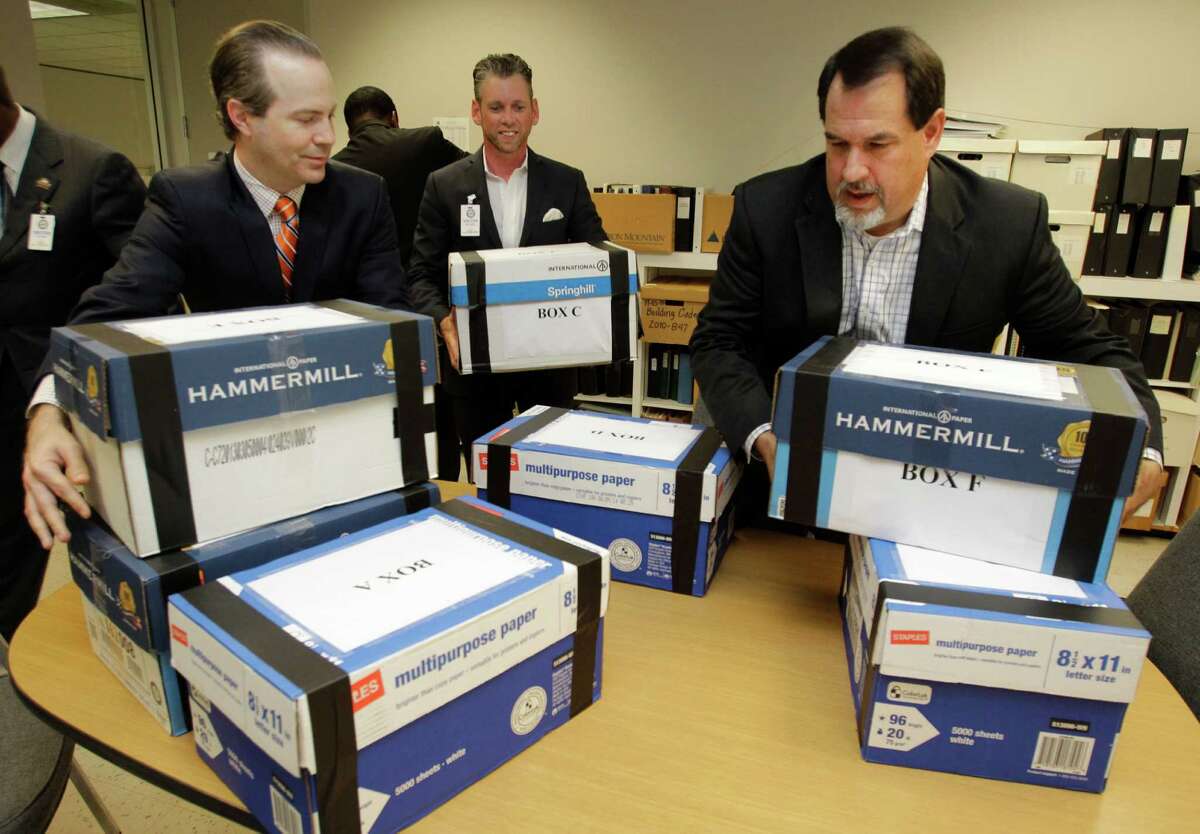 Jared Woodfill, left, David Welch, right, and others with a group seeking to repeal Houston's equal rights ordinance delivered boxes of signatures to the office of the Houston city secretary on July 3.