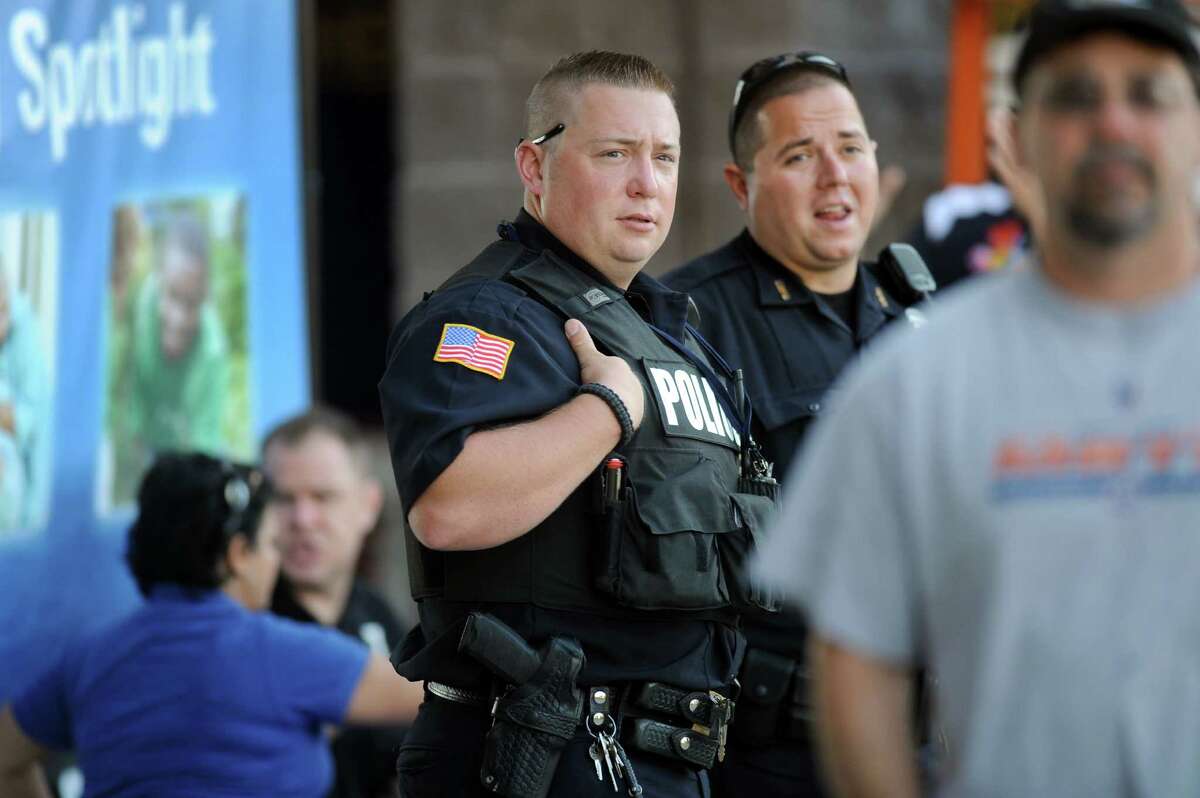 North Greenbush Police Officer Thomas Finn IV, center, and Troy Police Officer Charles Castle III keep watch during the ValleyCats baseball game on Thursday, July 24, 2014, at Bruno Stadium in Troy, N.Y. (Cindy Schultz / Times Union)