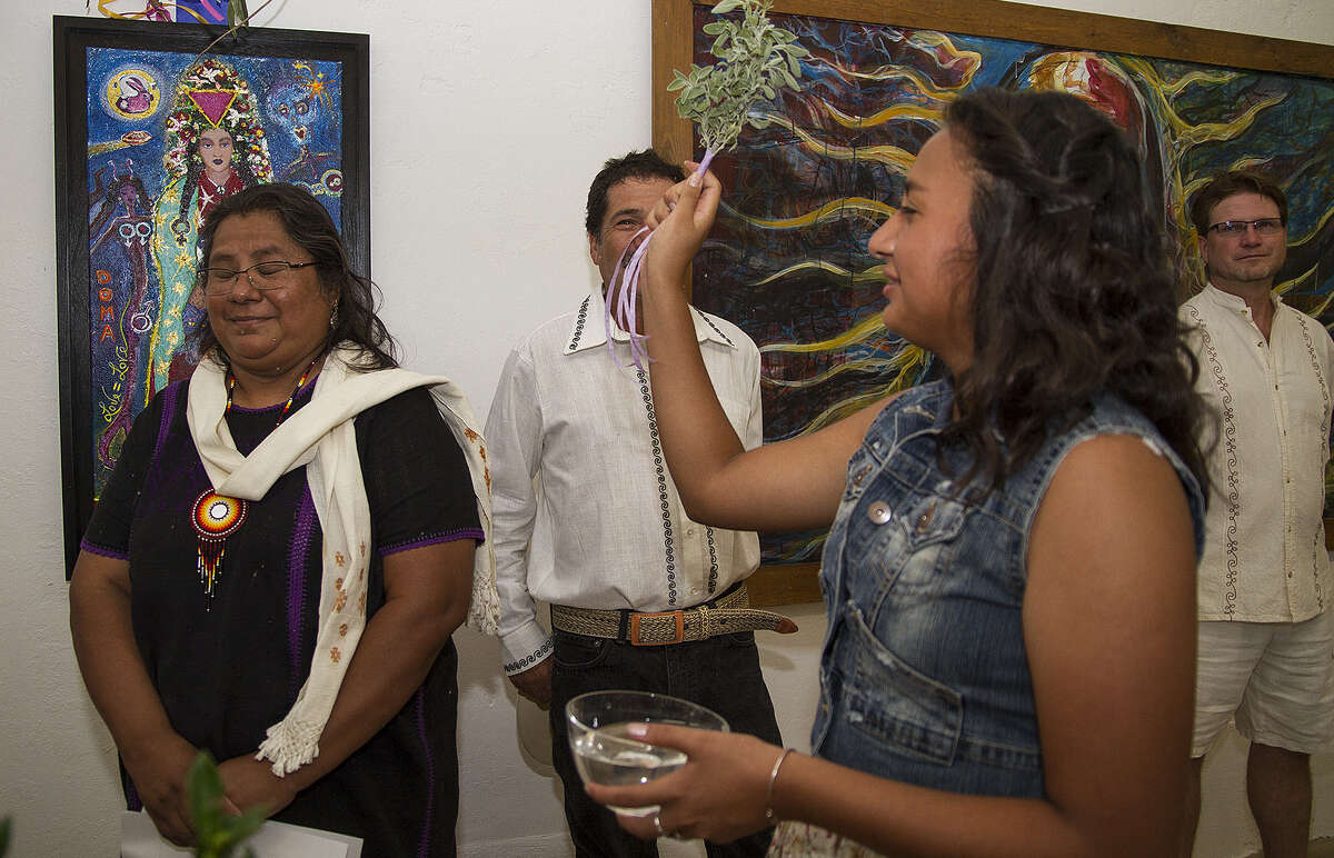 Veronica Alfonsina Castillo, 16, blesses her mom, Veronica Castillo, at the inaugural exhibition at Eco y Voces del Arte.