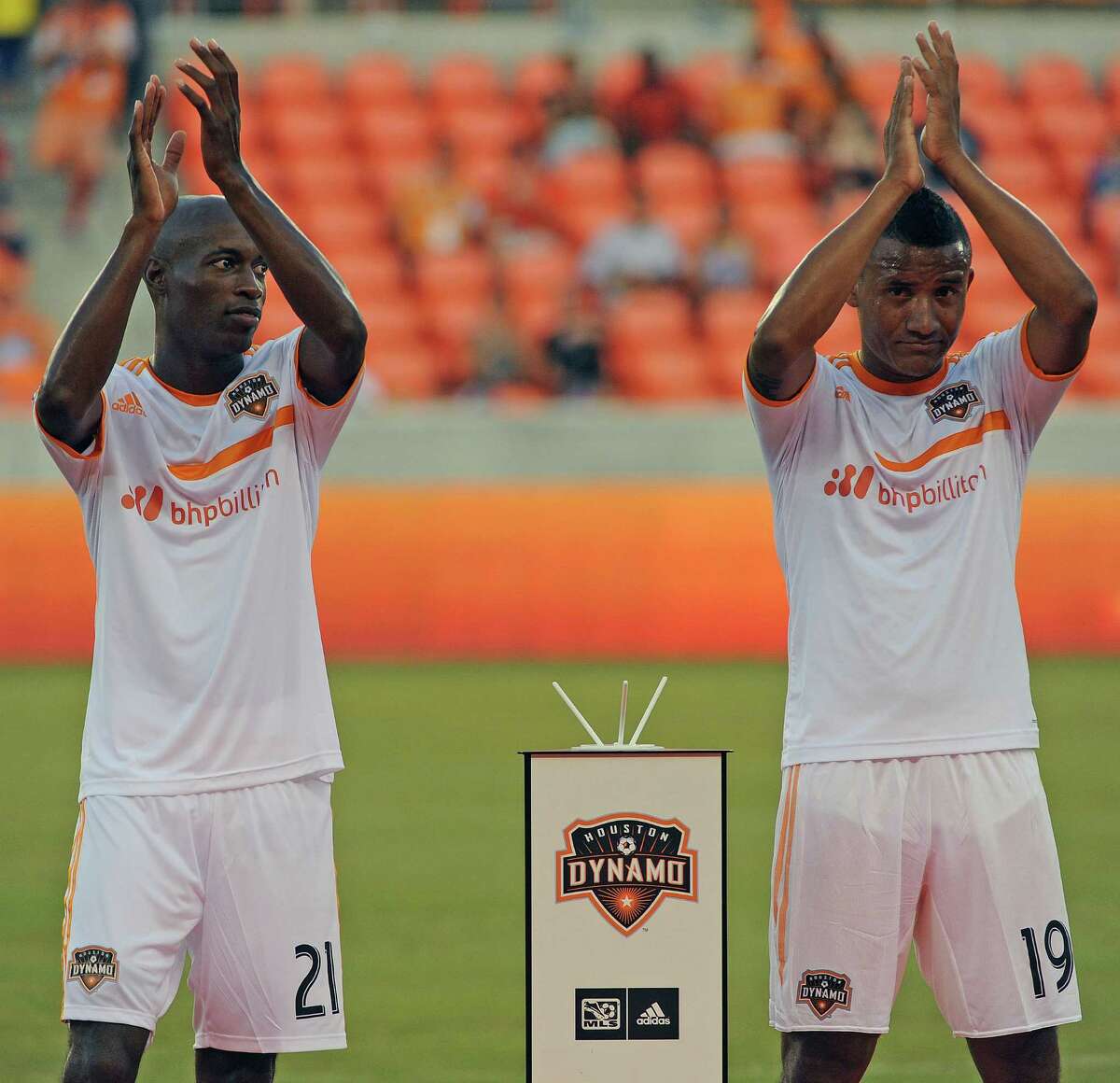 New Houston Dynamo players DaMarcus Beasley, left, and Luis Garrido acknowledge the crowd after being introduced before the BBVA Compass Dynamo Charities Cup against Aston Villa, Saturday, July 26, 2014, at BBVA Compass Stadium in Houston.