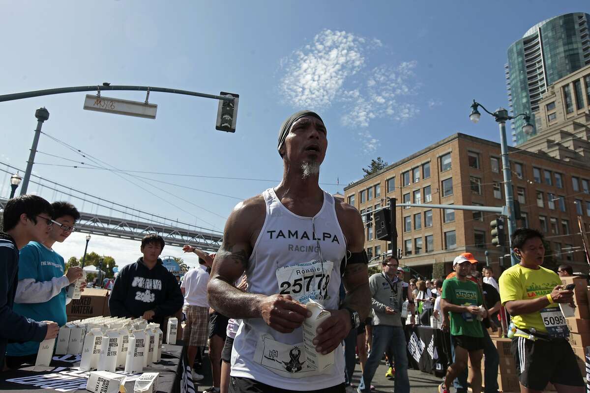 Ronnie Goodman gets a box of water after crossing the finish line of the San Francisco Marathon on Sunday, July 27, 2014 in San Francisco, Calif. Goodman is a homeless artist who lives in a tent under the freeway who has long dreamed of running in the marathon.