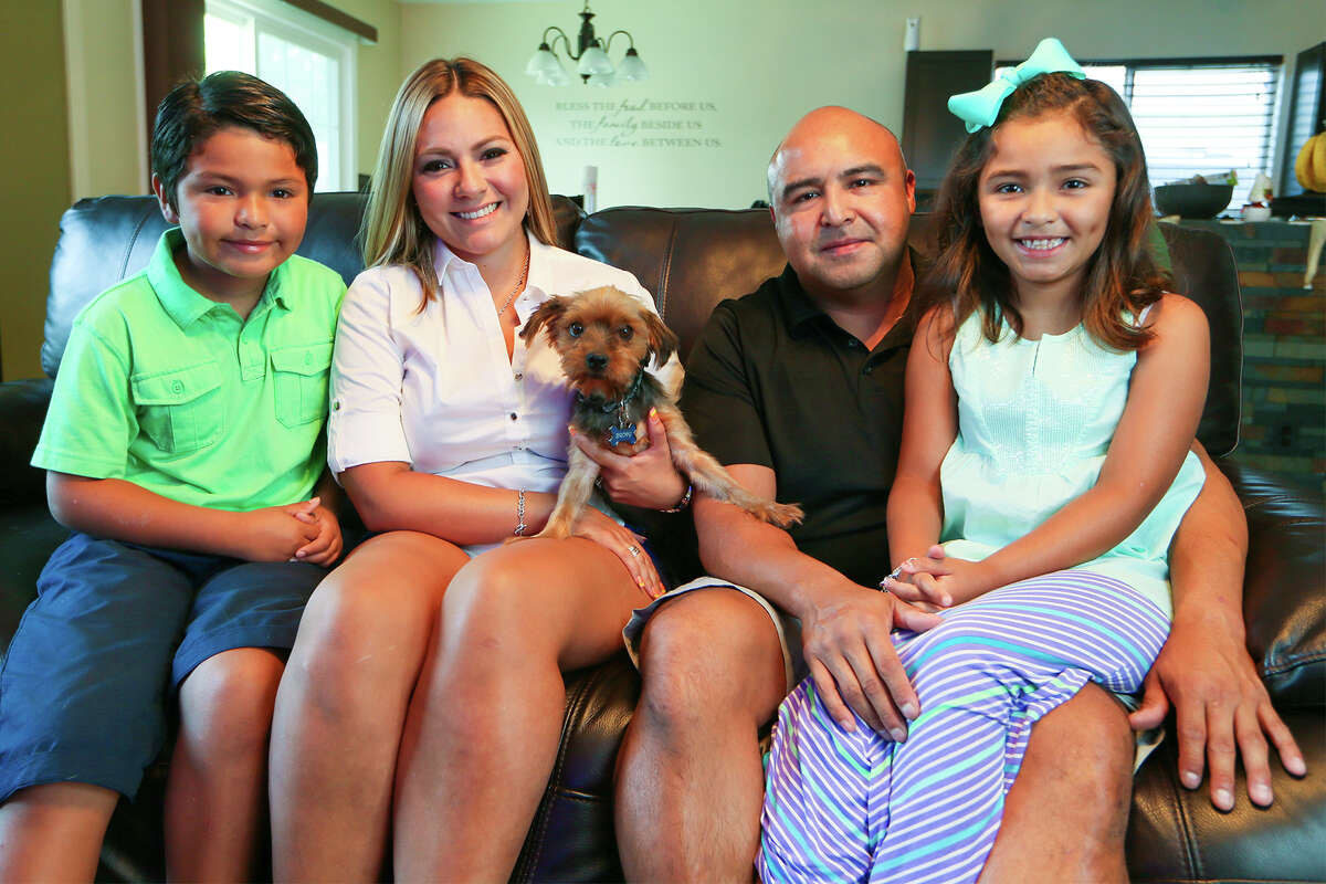 The Delgado family (from left) — Aidan Delgado, 7, Yvette Castillo, Juan Delgado and Leila Delgado, 7 — sit with Brody, their 6-year-old Yorkshire Terrier. Brody, who was picked up by Animal Care Services on July 16, was missing for sixteen months.