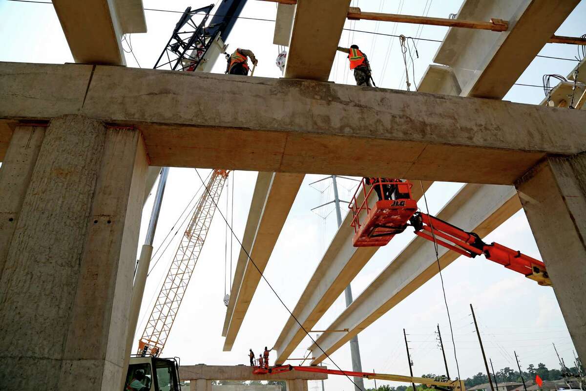A 123,000-pound girder is placed on the Rothwood Road bridge in Spring along the Grand Parkway.