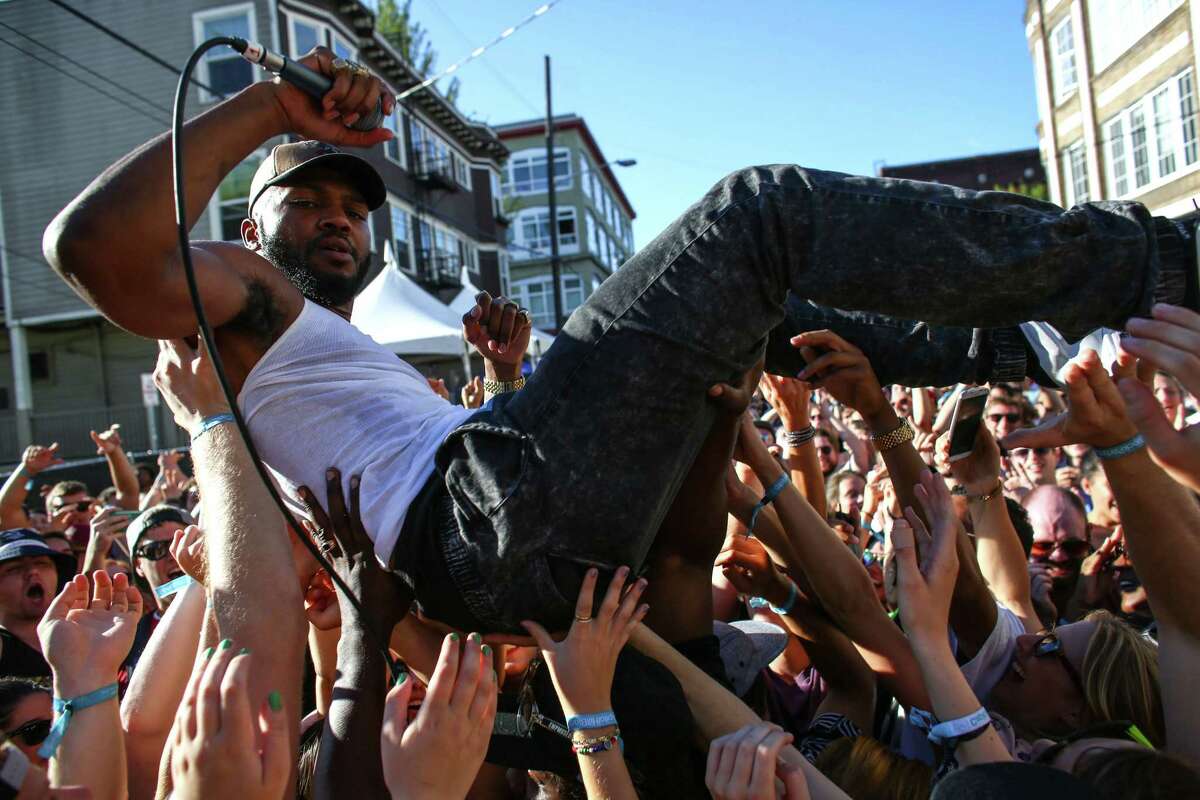 Hip hop artist Raz Simone is hoisted by the crowd on the final day of Capitol Hill Block Party on Sunday, July 27 2014. Spanning six blocks of the Seattle neighborhood, the festival features local and nationally acclaimed bands on six different stages.