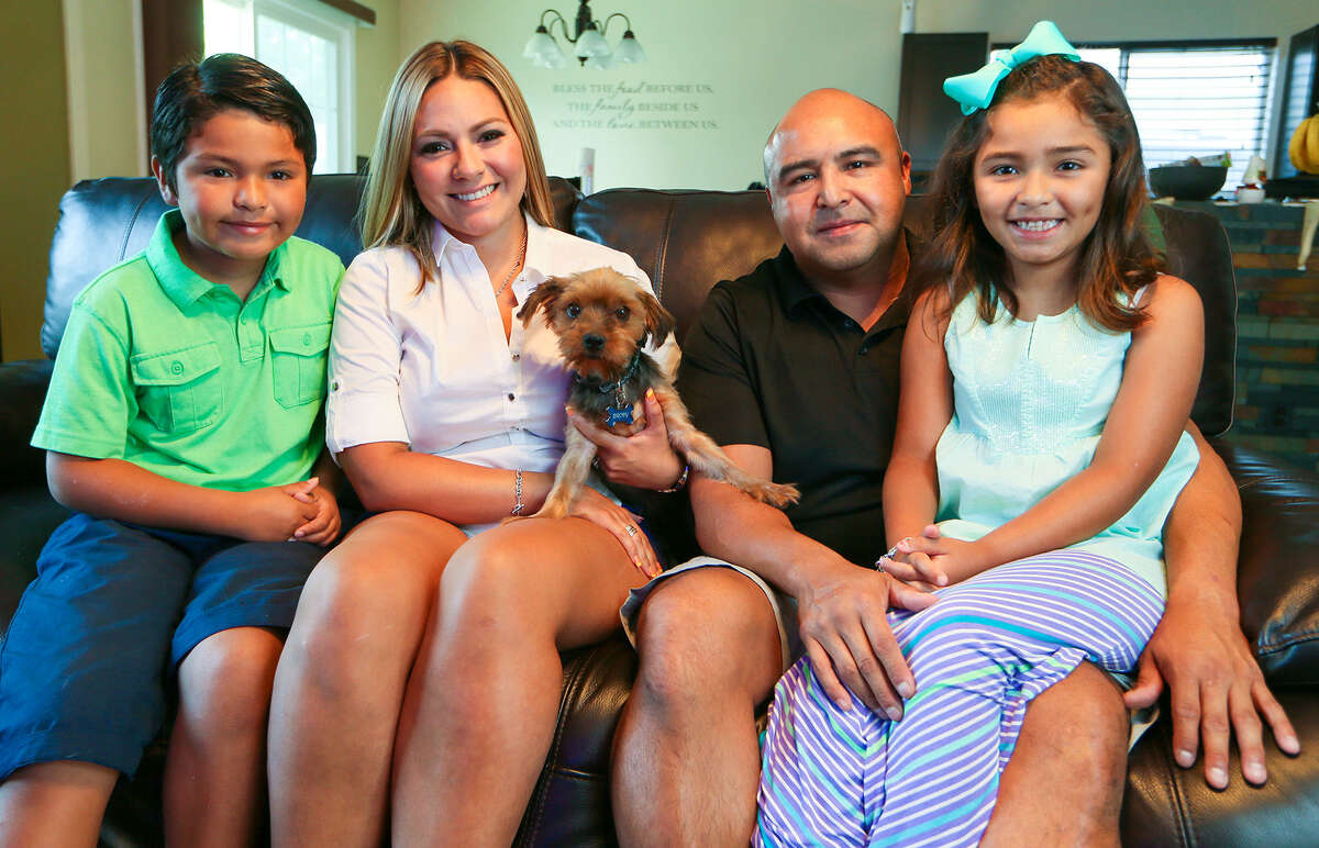 Aidan Delgado (from left), 7, Yvette Castillo, Juan Delgado and Leila Delgado, 7, with Brody, their six-year-old Yorkshire Terrier Brody was picked up by Animal Care Services on July 16 after being missing for sixteen months. ACS identified Brody from his microchip and notified the family. Photo by Marvin Pfeiffer / EN Communities
