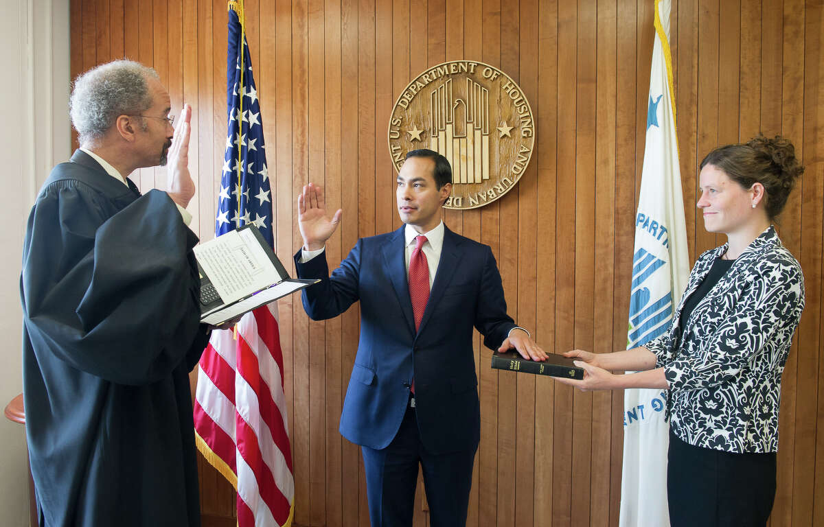 Julián Castro, center, is sworn in July 28, 2014 as the 16th Secretary for the U.S. Department of Housing and Urban Development.
