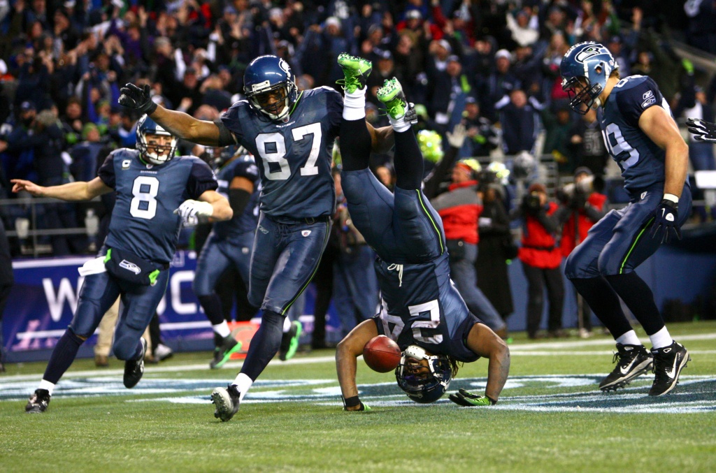 Seattle Seahawks running back Marshawn Lynch (24) dons his gloves during an  injury time out during the NFL Championship Game against the San Francisco  49ers at CenturyLink Field in Seattle, Washington on