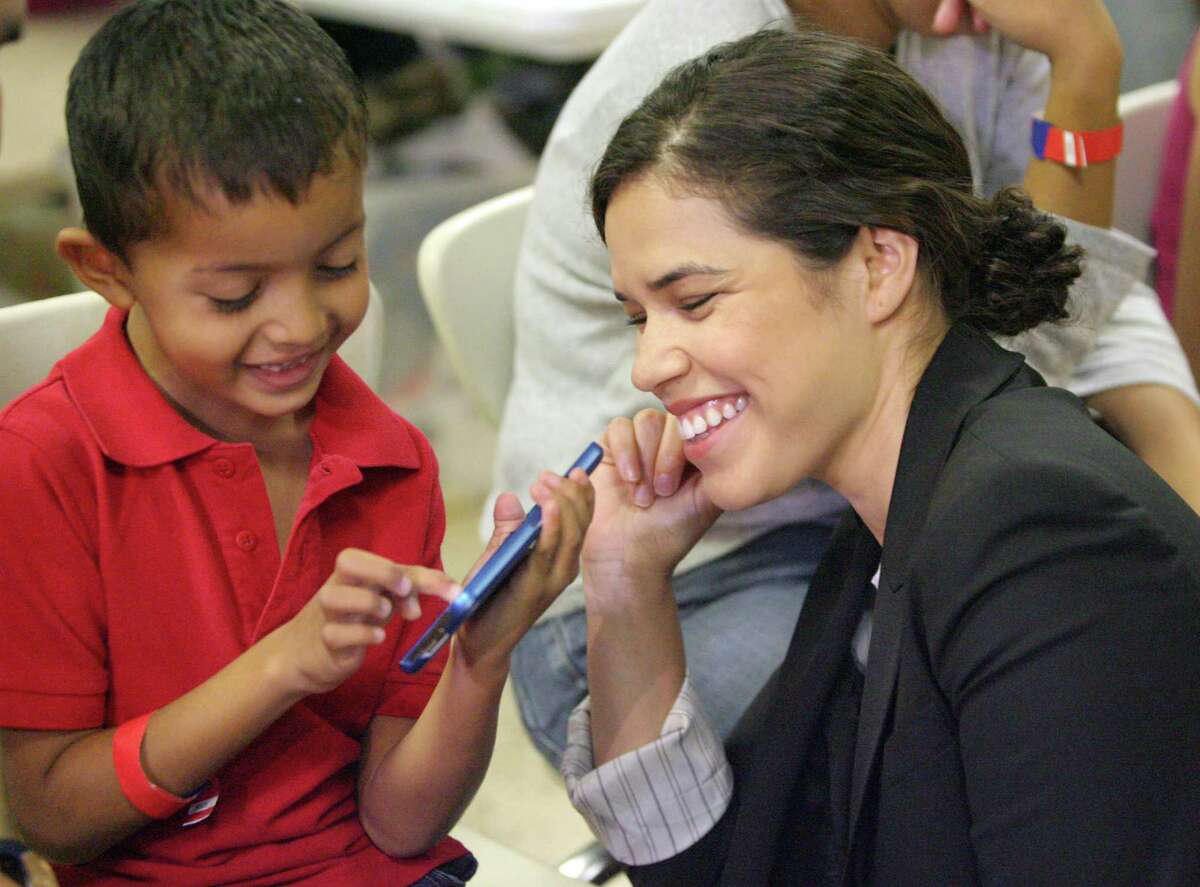 MCALLEN,TX-July 28,2014- Actress America Ferrera plays with a Central American boy during the Hispanic Heritage Foundation humanitarian project at Sacred Heart in McAllen Monday July 27,2014. Photo by Delcia Lopez/McAllen Monitor