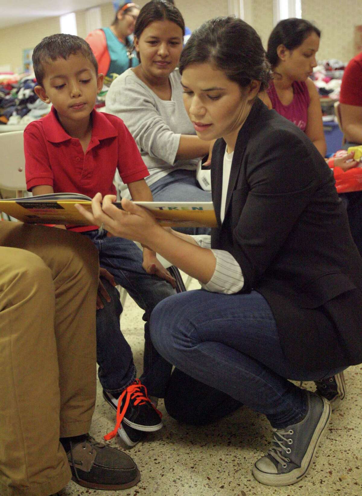 MCALLEN,TX-July 28,2014- Actress America Ferrera plays with a Central American boy during the Hispanic Heritage Foundation humanitarian project at Sacred Heart in McAllen Monday July 27,2014. Photo by Delcia Lopez/McAllen Monitor