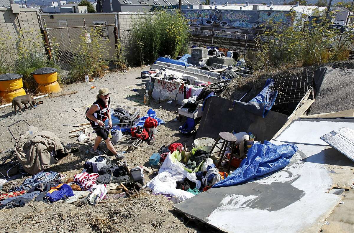 At the rear of the vacant lot off Second Street, several homeless live near the train tracks Tuesday July 29, 2014. A homeless community that began in Albany, then moved to the Gilman Street freeway underpass in Berkeley, Calif. has scattered although some are now in a vacant lot off Second Street.