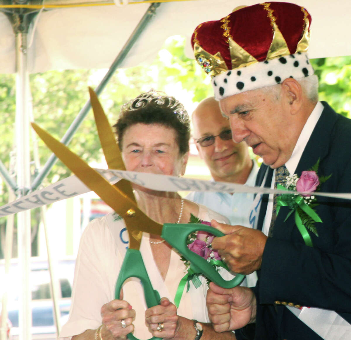 King and Queen Roland and Mary Miller handle the ribbon-cutting with aplomg as state Sen. Clark Chapin (R-30th) looks on during the opening ceremony for the Greater New Milford Chamber of Commerce's 47th annual Village Fair Days for July 25-26, 2014 on the Village Green and environs.