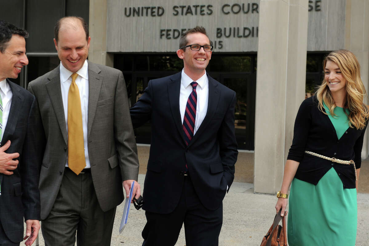 Johnathan Nathans, center, a former Bridgeport Bluefish player, leaves Federal Court in Bridgeport, Conn. after receiving a favorable verdict in his lawsuit against Jose Offerman, a former Long Island Ducks player who charged the pitcher's mound swinging a bat during a 2007 game. Nathans, a catcher for the Bluefish, said that he was injured in the incident, and was awarded $940,000. He is seen here with his wife, Kate Lawrence, and attorneys Josh Koskoff, far left, and Craig Smith.