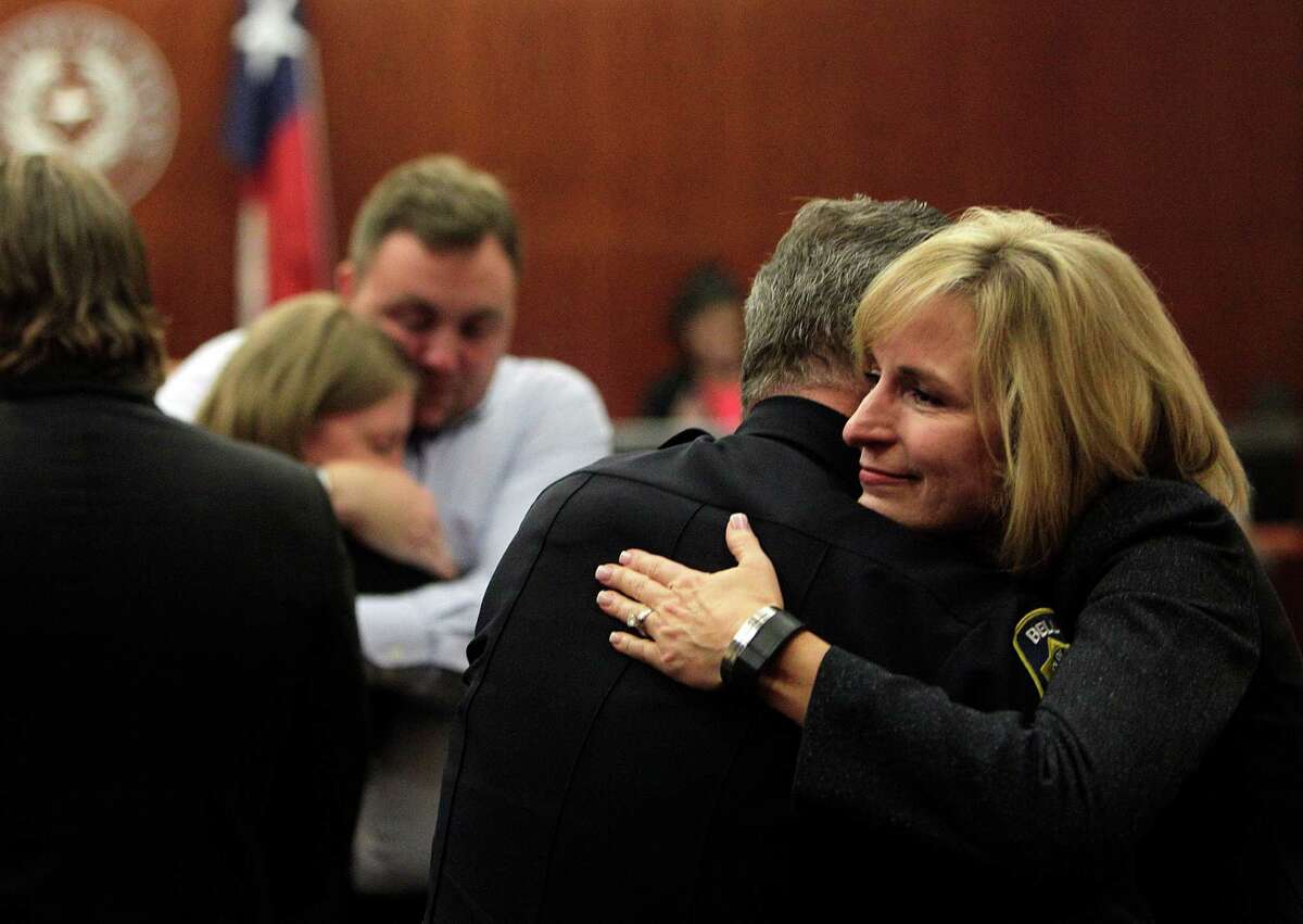 Bellaire Police Officer Doug Clausen is embraced by District Attorney Devon Anderson after jurors sentence Harlem Lewis to death after deliberating 12 hours over 2 days at the Harris County Criminal Courthouse on Tuesday, July 29, 2014, in Houston.