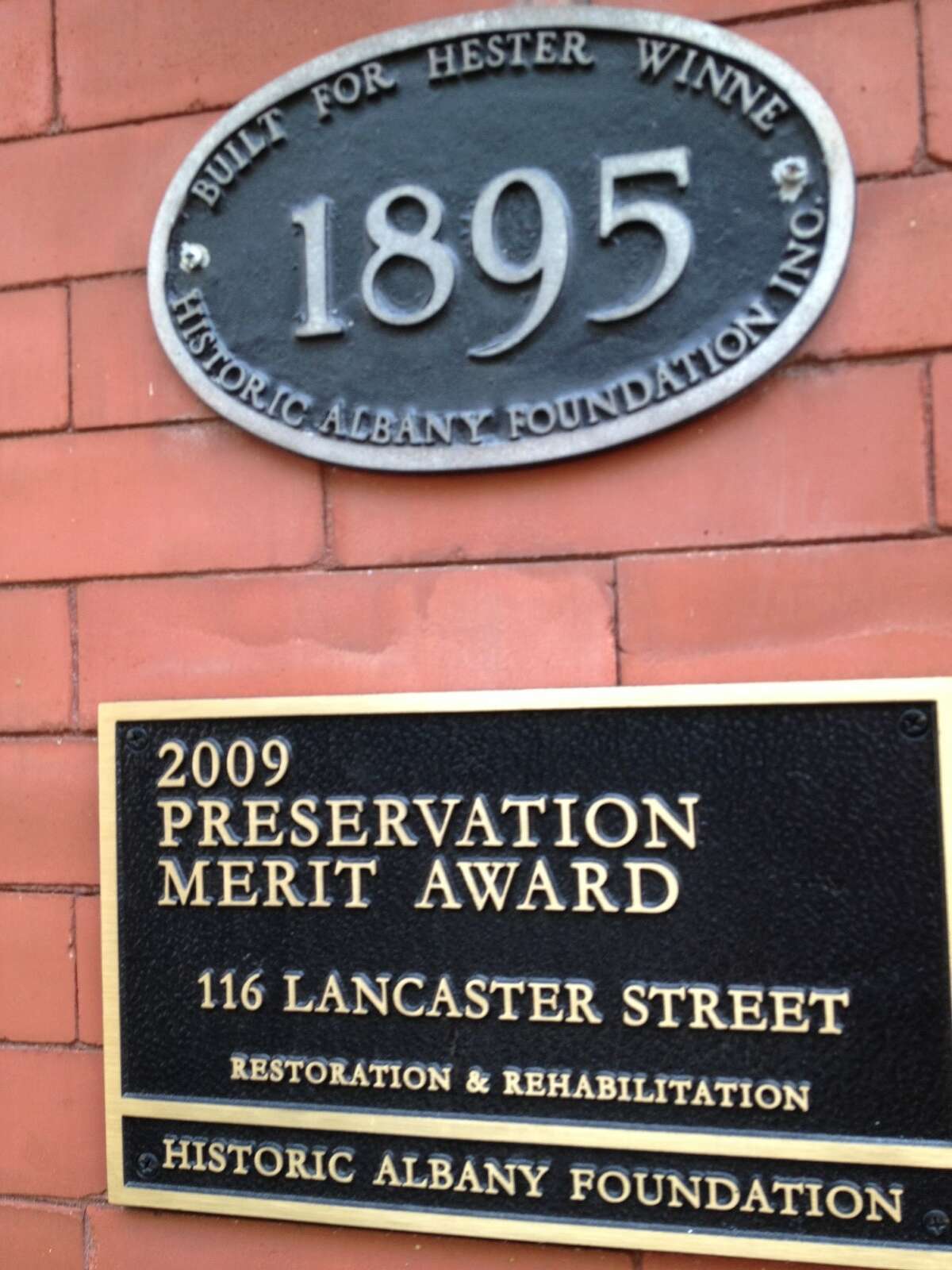 Historic plaque and preservation award on home of Tony and Bonnie Mariano at 116 Lancaster St. in Albany's Center Square that was built in 1895 by Hester Slingerland Winne, a descendant of the Slingerlands, one of the earliest Dutch settlers. (Paul Grondahl / Times Union)