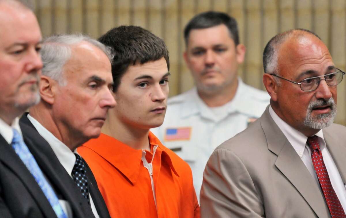Christopher Plaskon, 18, third from left, appears in Superior Court in Milford, Conn., on Wednesday, June 4, 2014. Plaskon, charged with stabbing a classmate to death in school on their prom day, pleaded not guilty to murder Wednesday as his attorney said he was investigating a possible mental health defense. From left, are attorney Edward Gavin, Plaskon's uncle and guardian Paul Healy, Plaskon and attorney Richard Meehan Jr.