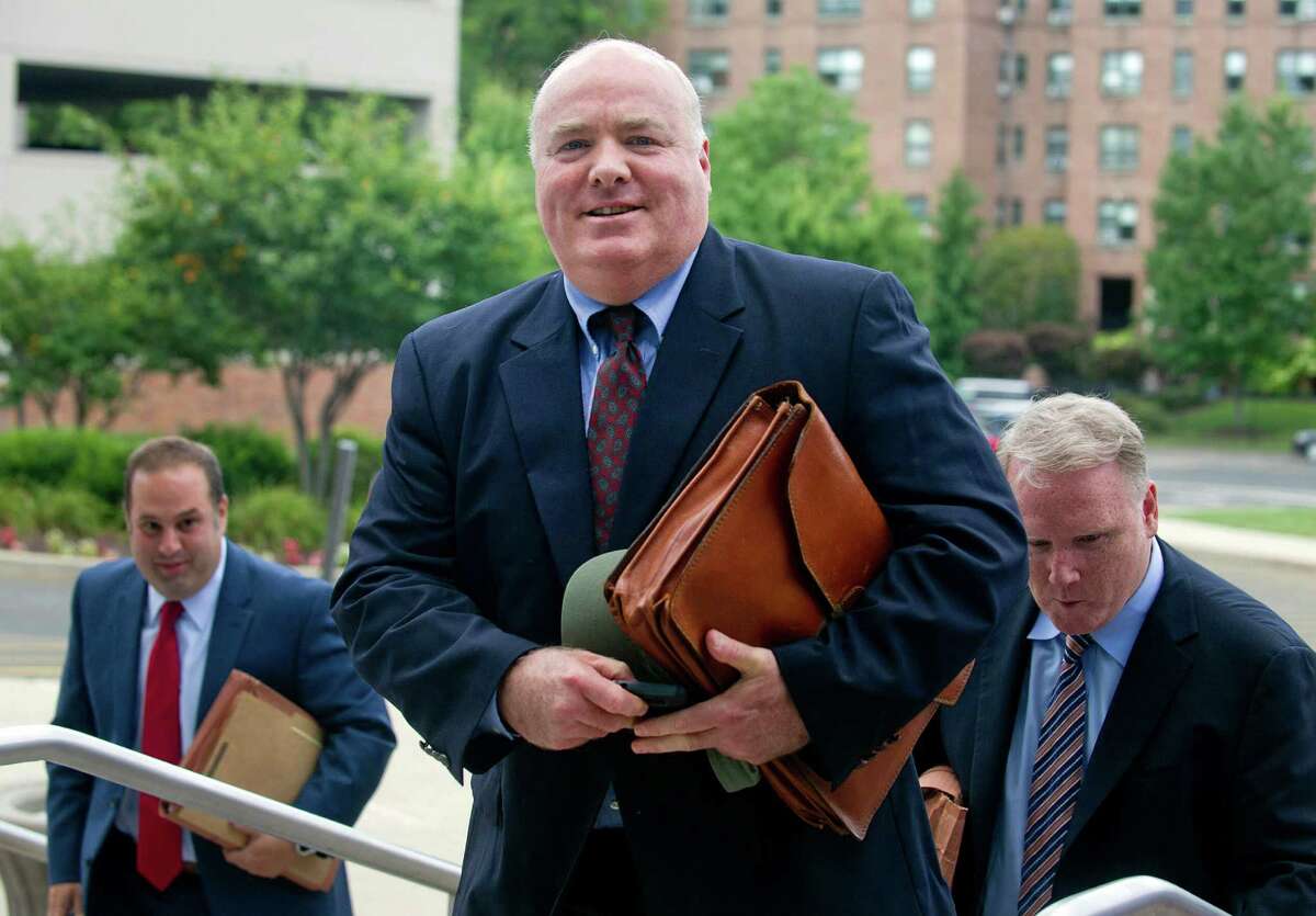 Michael Skakel, right, arrives at State Superior Court in Stamford, Conn., on Wednesday, July 30, 2014, with his attorney, Stephan Seeger, right.