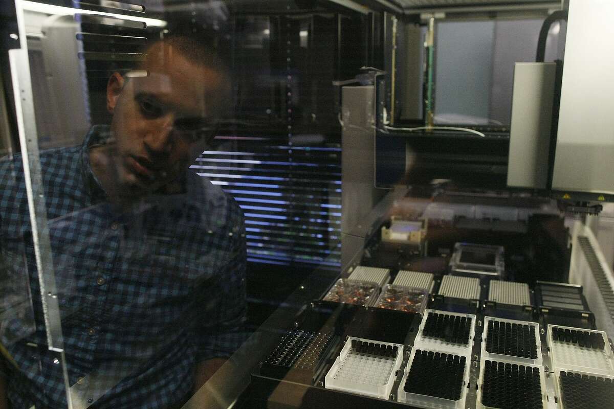 DJ Kleinbaum, co-founder of Emerald Cloud Labs, looks at a liquid handler on Tuesday, July 29, 2014 in Menlo Park, Calif. Companies such as Emerald Cloud Labs offer others to use their machinery to do experiments.