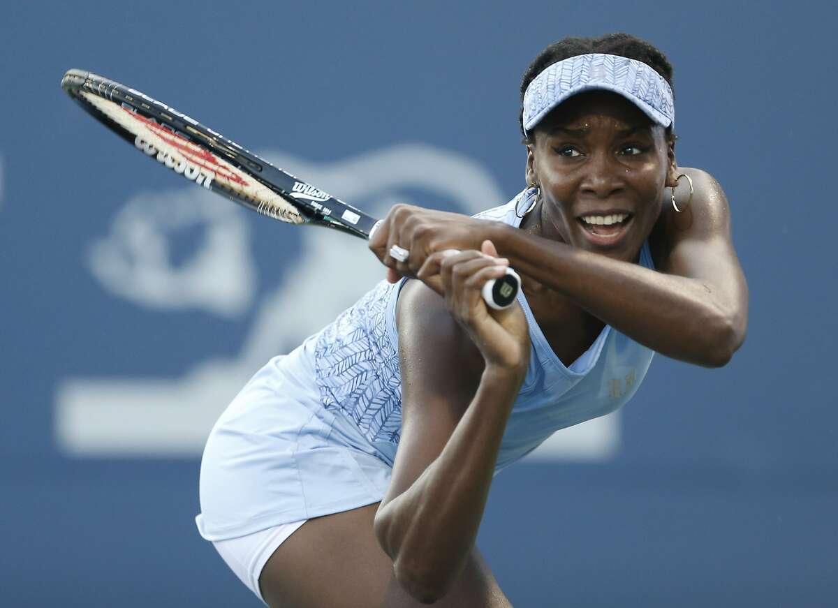 Venus Williams returns the ball during the second set of her match against Paula Kania in the Bank of the West Classic, Tuesday, July 29, 2014, in Stanford, Calif. (AP Photo/Beck Diefenbach)