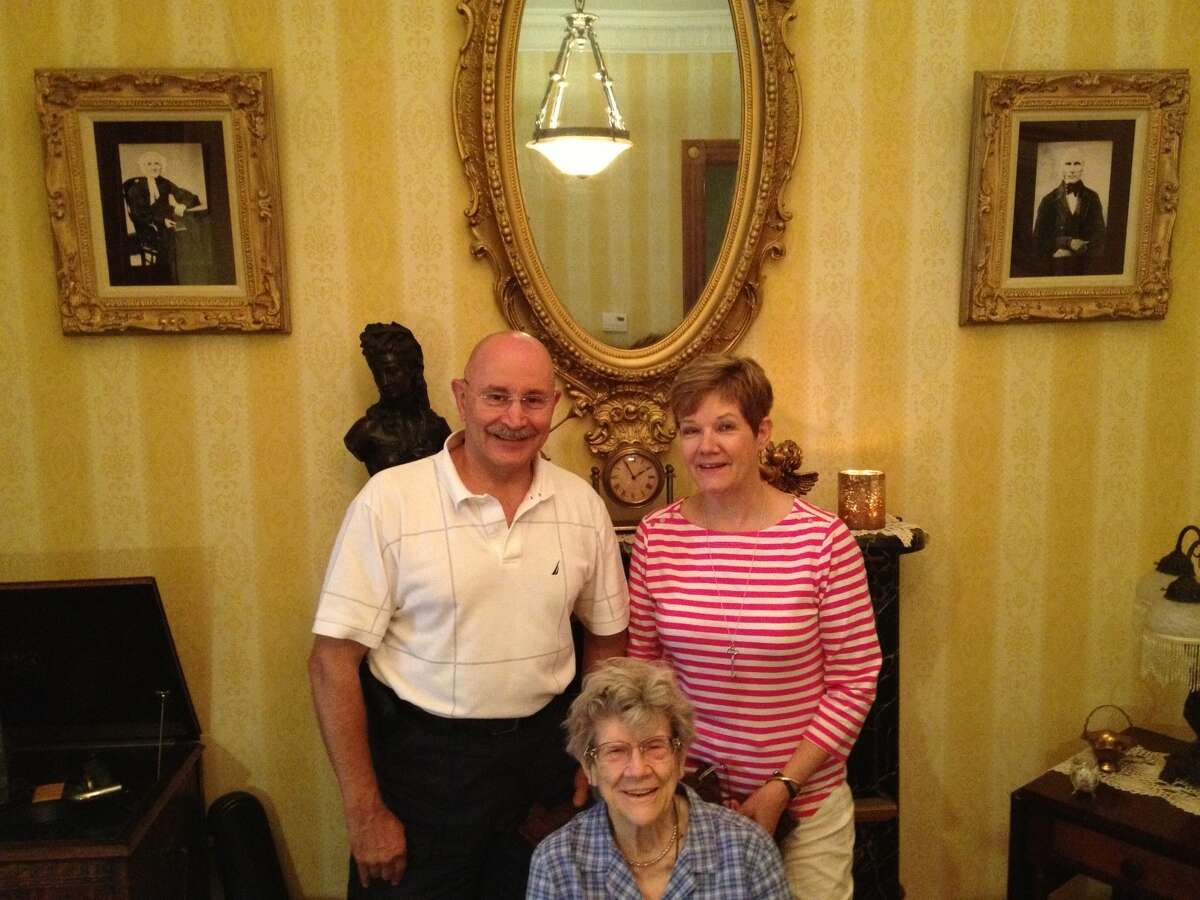 Tony and Bonnie Mariano pose with 90-year-old Martha Slingerland, archivist of the old Dutch family she married into. She was given a tour of the Mariano's Lancaster Street townhouse that Hester Slingerland Winne built in 1895. The Marianos have meticulously restored the Victorian house and researched its history, with the help of Slingerland. (Paul Grondahl / Times Union)