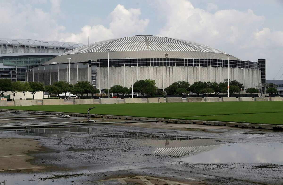 The Astrodome looms above a parking lot full of tailgaters on Oct. 9, 2010. A Texas agency is reviewing a proposal to protect the so-called Eighth Wonder of the World from demolition by designating it as a "state antiquities landmark."