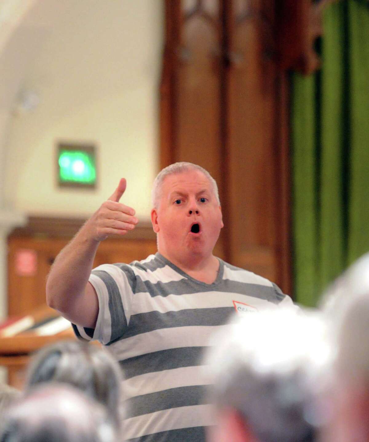Dr. Craig Scott Symons, director of music at First Congregational Church in Old Greenwich, leads the "Summer Sings" session at the church in the Old Greenwich section of Greenwich, Conn., Wednesday night, July 30, 2014.