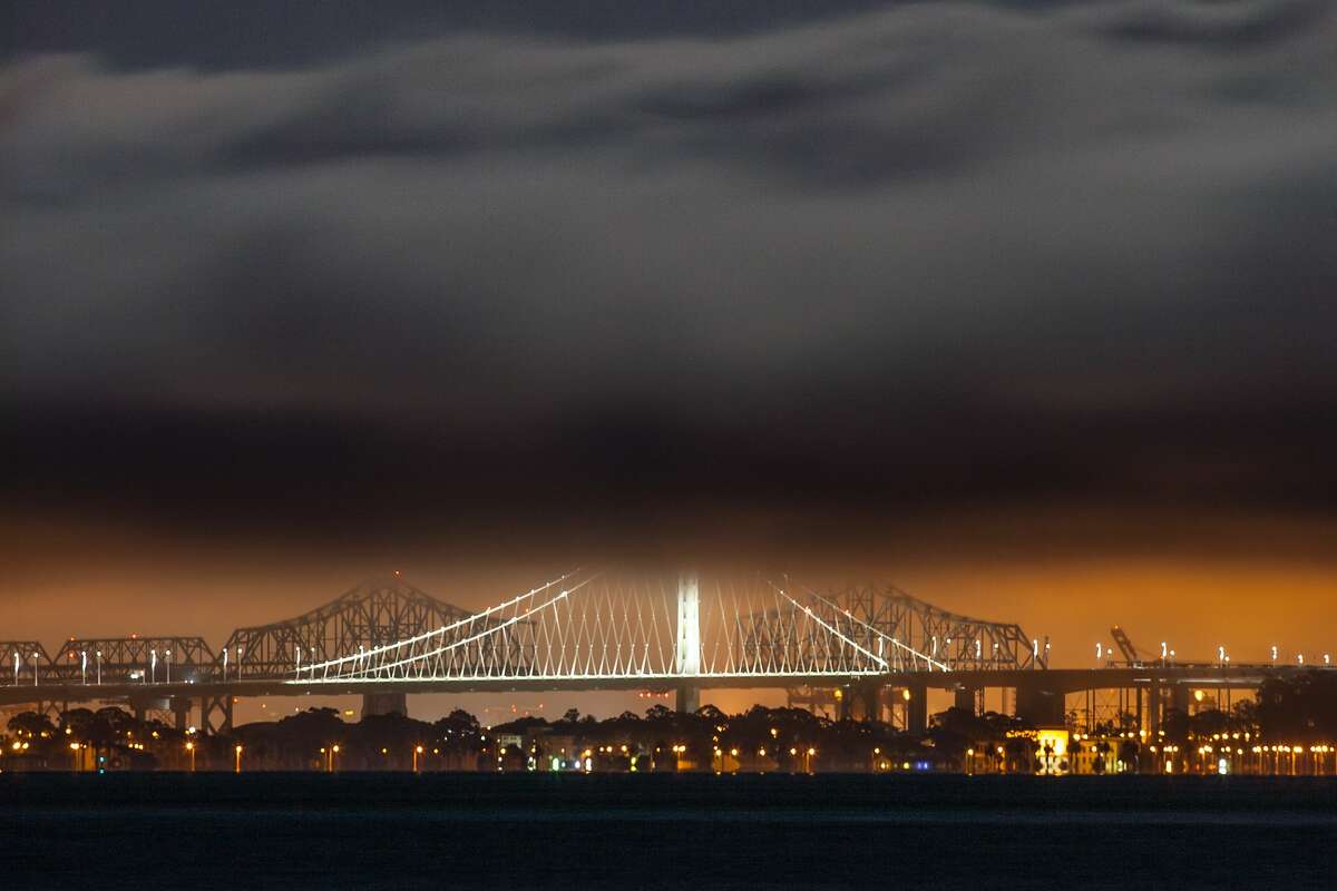 The Eastern Span of the San Francisco/Oakland Bay Bridge is shrouded in fog after the rising of the Supermoon on July 12, 2014 as seen from Sausalito, CA.