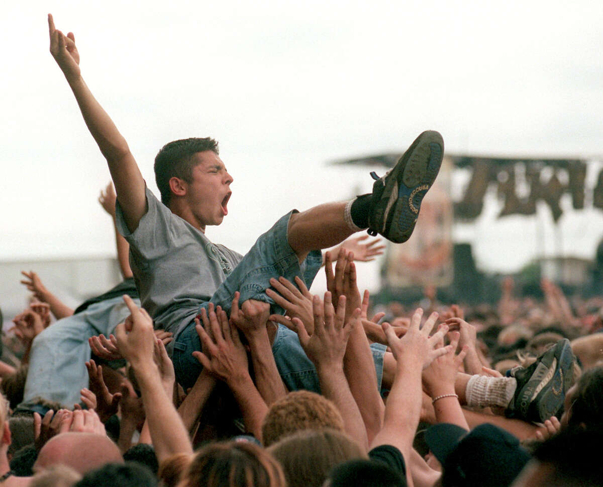 An Ozzfest fan crowd surfs over heavy-metal fans at Retama Park Polo Ground in 1999.