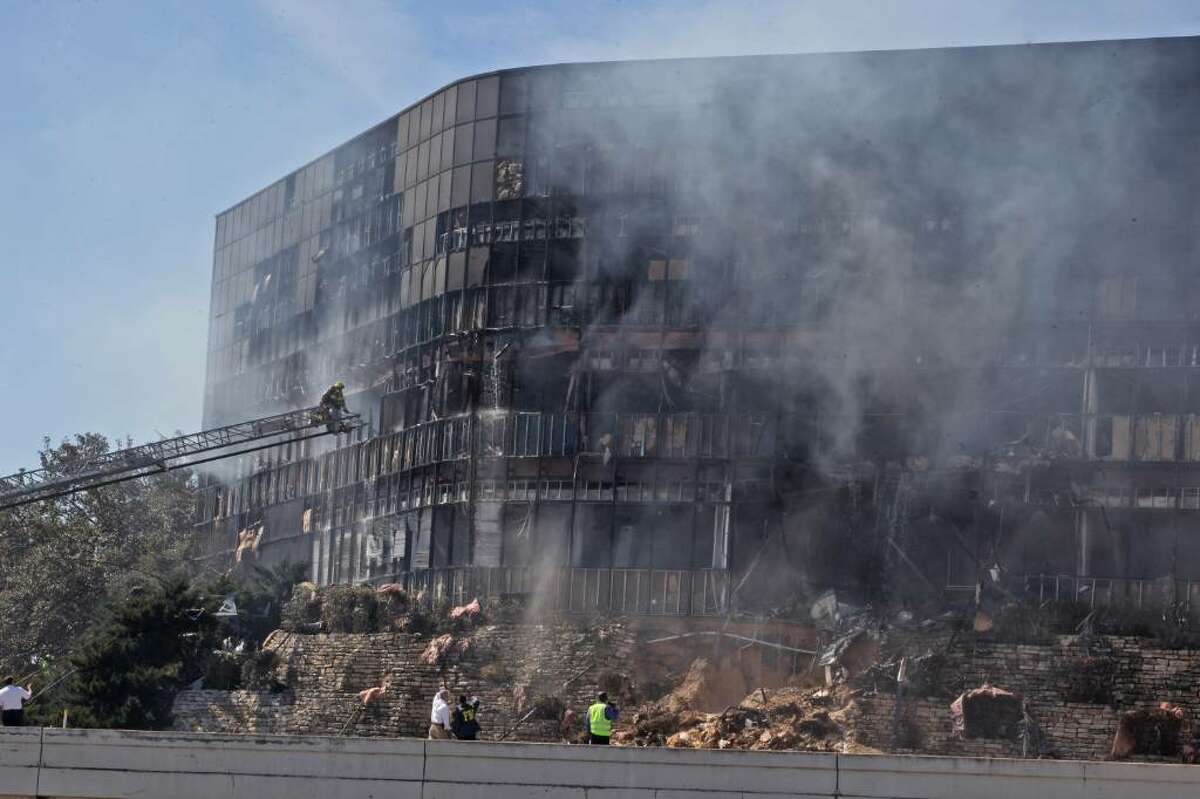 AUSTIN, TX - FEBRUARY 18: Smoke billows from a building that houses IRS offices after a small plane crashed into it February 18, 2010 in Austin, Texas. According to reports, the pilot, identified as Joseph A. Stack III, was killed in the crash. (Photo by Jana Birchum/Getty Images)