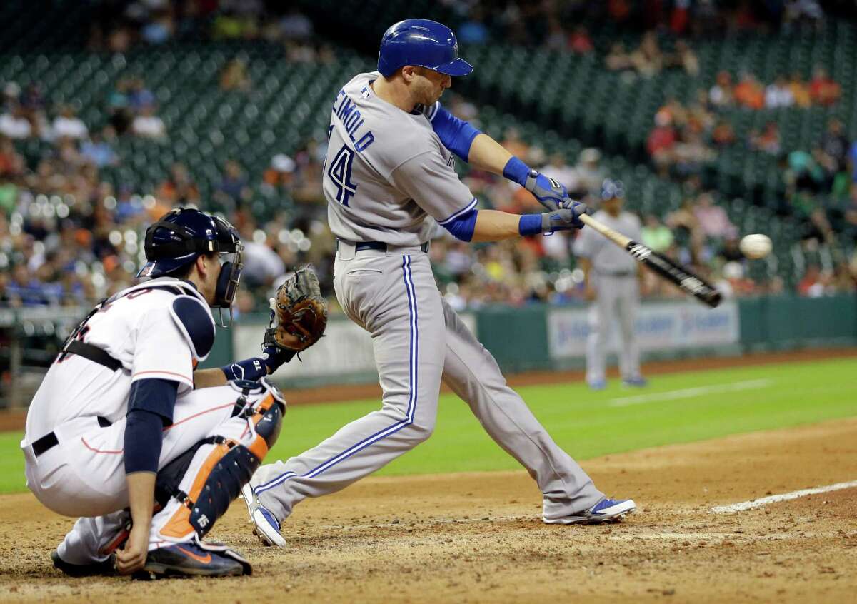 Toronto Blue Jays' Nolan Reimold (14) hits a home run as Houston Astros catcher Jason Castro, left, reaches for the pitch during the ninth inning of a baseball game Thursday, July 31, 2014, in Houston. (AP Photo/David J. Phillip) ORG XMIT: TXDP125