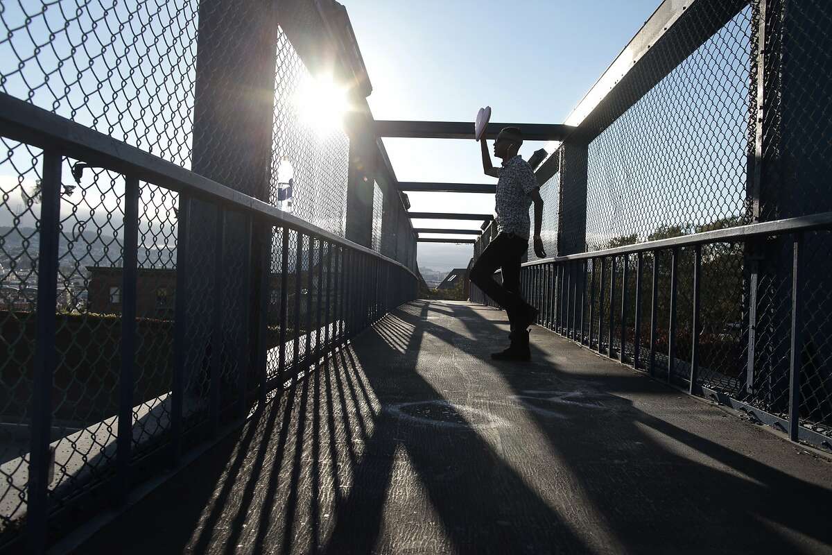 Javonne Hatsfield performs over 101 with his signature heart in hand on Thursday, July 10, 2014 in San Francisco, Calif. Hatsfield has been dancing on this overpass over 101 every Thursday and Friday for the past year.