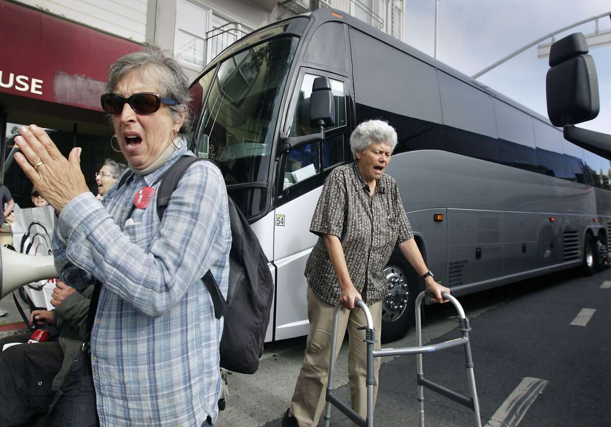 A group of seniors and disabled residents, protesting against the tech industry and its workers, block two shuttle buses picking up tech employess at 24th and Valencia streets in San Francisco, Calif. on Friday, Aug. 1, 2014.