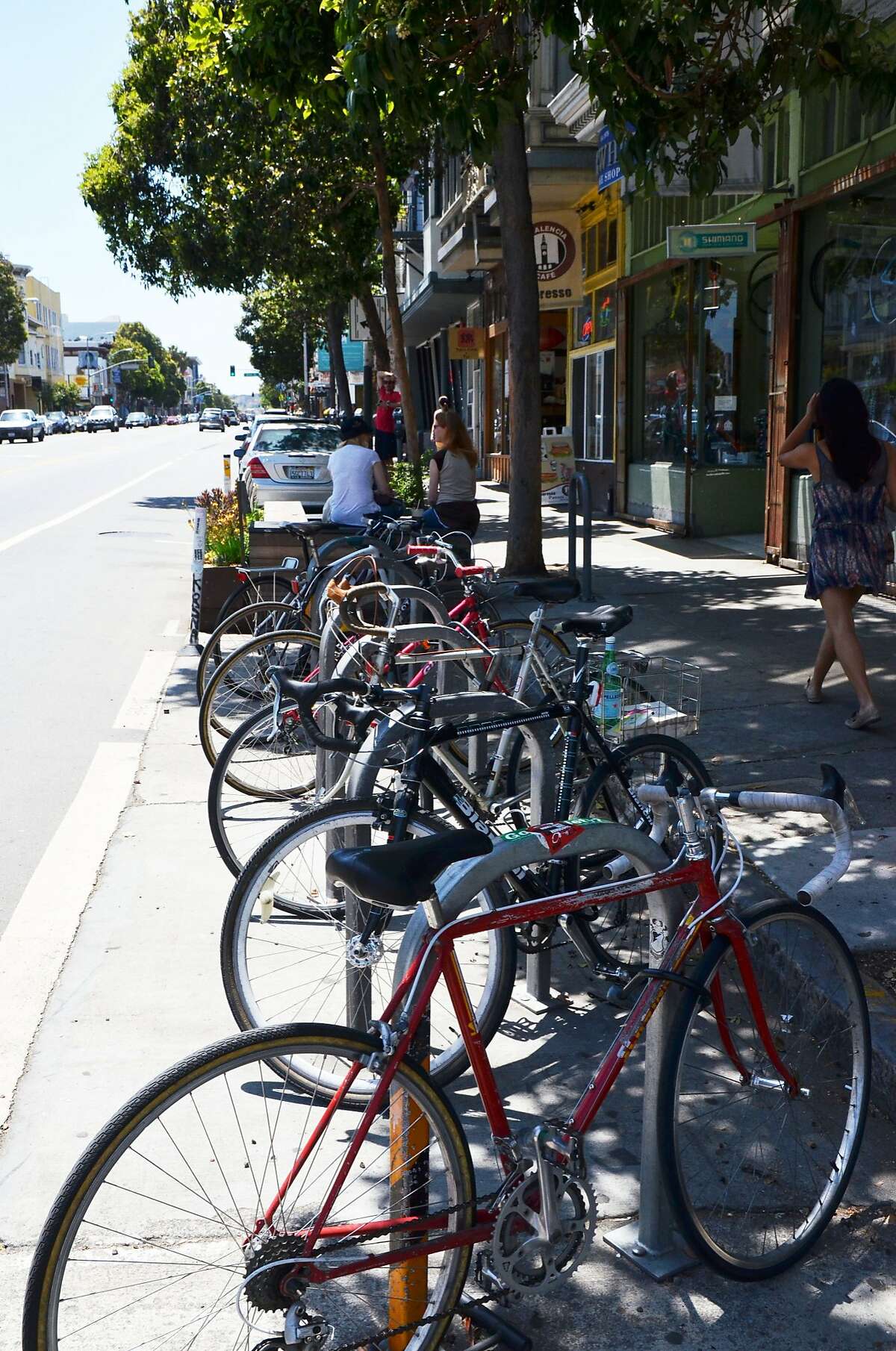 An on-street bike corral on Valencia Street comfortably holds 12 bikes and keeps the sidewalks clear for pedestrians. Requesting bike racks or bike corrals are two ways San Francisco bicyclists can directly improve their commute.