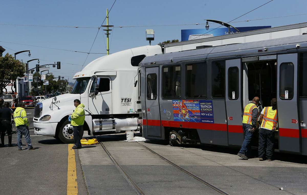 A collision between a big rig truck and a MUNI light rail vehicle at the intersection of Innes and 3rd streets shut down both north and south bound lanes of 3rd street as emergency personnel responded to the scene in San Francisco, Calif. on Friday August 01, 2014.