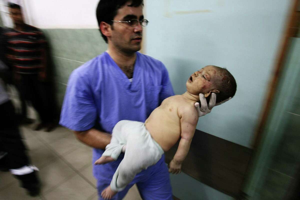 Man holding baby rafah