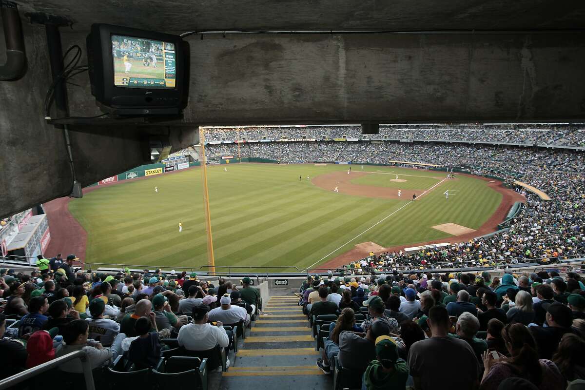 A television shows the game for fans at the Oakland Coliseum on Friday, August 1, 2014 in Oakland, Calif. The Oakland Athletics soon have to find out how to build a new stadium.