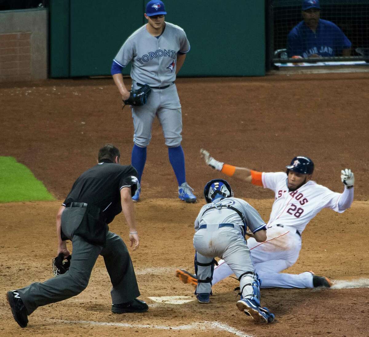 He originally was ruled out, but a review of the play showed that Astros first baseman Jon Singleton slid under the tag of Blue Jays catcher Josh Thole to complete an inside-the-park home run in the eighth inning.