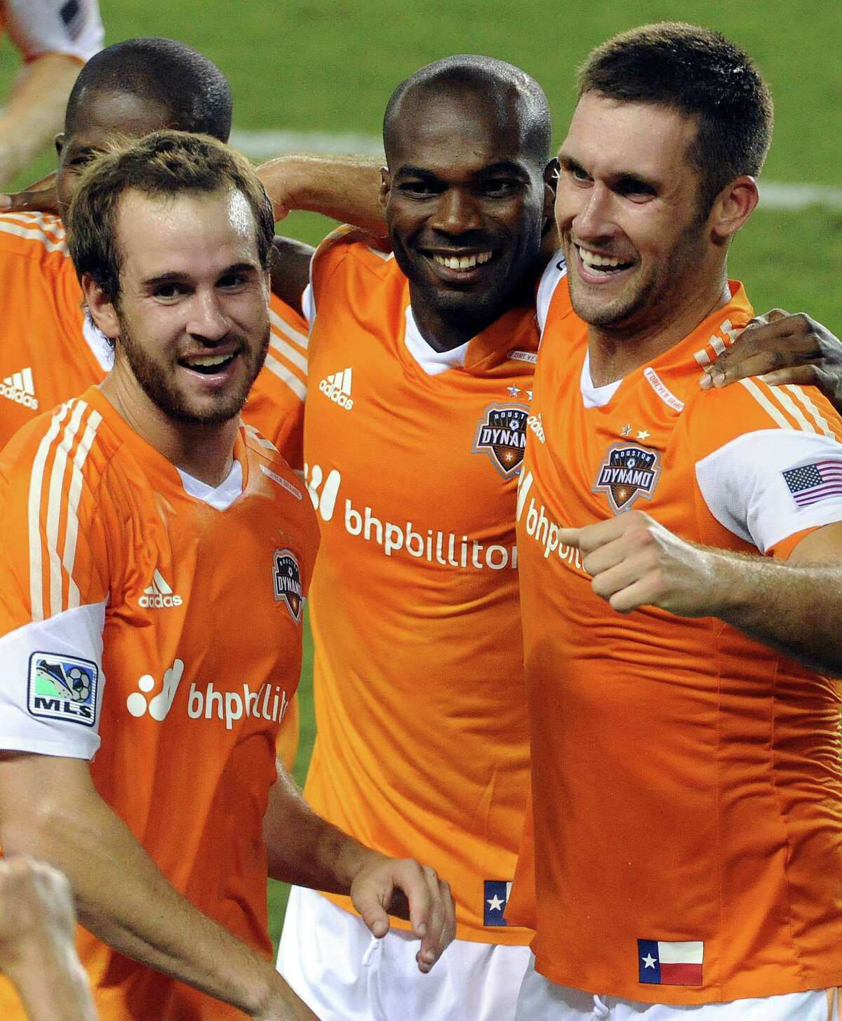 Houston Dynamo forward Will Bruin, right, celebrates his game-winning goal in the 90th minute with Brian Ownby, left, and Omar Cummings during the second half of an MLS soccer game against D.C. United, Sunday, August 3, 2014, at BBVA Compass Stadium in Houston.